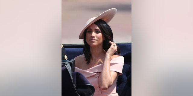 Meghan, the Duchess of Sussex rides in a carriage with Britain's Prince Harry, during the Trooping the Colour ceremony at Horse Guards Parade as the Queen celebrates her official birthday, in London, Saturday June 9, 2018.