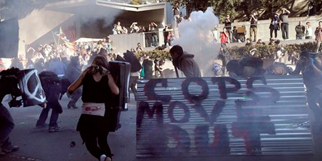 January 28, 2012: Oakland police deploy smoke and tear gas to stop protesters with the Occupy Oakland as they march through the streets of downtown Oakland, Calif.