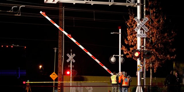 Jan. 28, 2012: Officials test the signals and lights at an intersection where an SUV and Light Rail train collided in Sacramento, Calif.