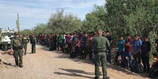 Border Patrol authorities say 128 immigrants believed abandoned by smugglers in a remote desert area at the Arizona border with Mexico are facing deportation.