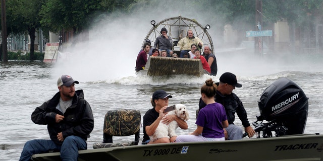 People are rescued from flood waters from Hurricane Harvey on an air boat in Dickinson, Texas August 27, 2017.