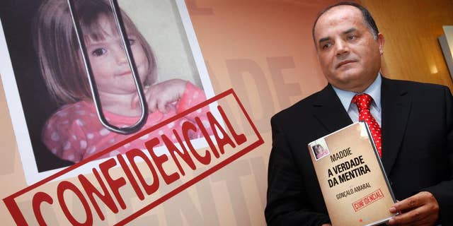 FILE- In this July 24, 2008 file photo, former detective Goncalo Amaral in the Madeleine McCann case poses next to her photo with his book, whose title translates as "The Truth in the Lies", during its launch in Lisbon. British detectives say they are still pursuing "critical" leads in the case of the disappearance of Madeleine McCann, 10 years after the girl — then three years old — vanished from a vacation home in Portugal. Metropolitan Police Assistant Commissioner Mark Rowley said Wednesday, April 26, 2017 there are "significant investigative avenues ... of great interest" to detectives both in Britain and in Portugal. (AP Photo/Joao Henriques, file)