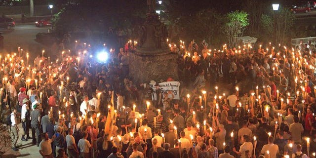 White nationalist marchers are seen on the University of Virginia campus on Aug. 11, 2017.