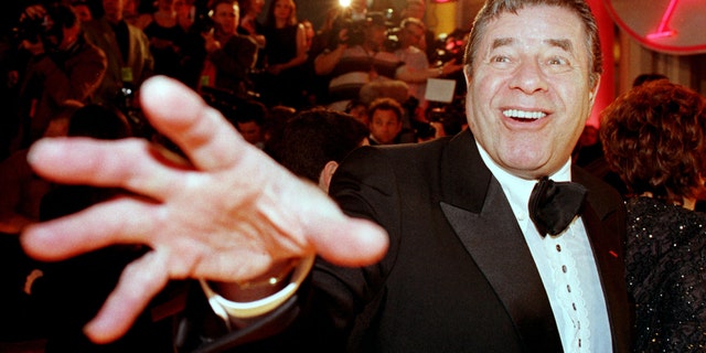 Comedian Jerry Lewis reaches out to cover the camera lens as he arrives at the 12th annual American Comedy Awards, February 22 in Los Angeles where he was honored with the Lifetime Achievement Award. - RTXIIUQ
