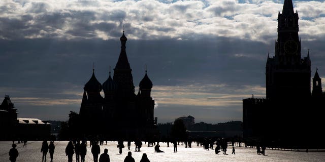 People walk at Red Square in Moscow, Russia, Monday, Sept. 26, 2016. The Red Square is considered the main square of the capital and has held outdoor markets, festivals, and parades. (AP Photo/Pavel Golovkin)