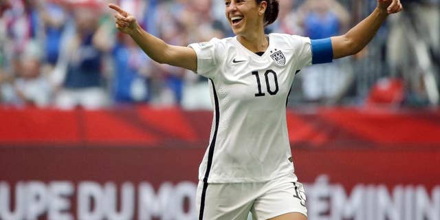 Carli Lloyd of the U.S celebrates scoring her third goal against Japan during the first half of the FIFA Women's World Cup soccer championship in Vancouver, British Columbia, Canada.