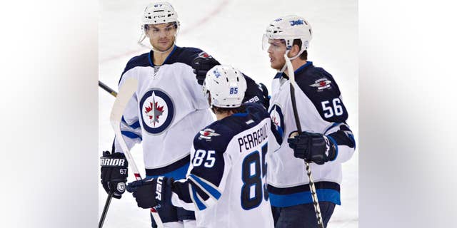 Winnipeg Jets Michael Frolik (67), Mathieu Perreault (85)and Adam Lowry (56) celebrate a goal against the Edmonton Oilers during second period NHL hockey action in Edmonton, Alberta, on Monday, Sept. 29, 2014.(AP Photo/The Canadian Press, Jason Franson)