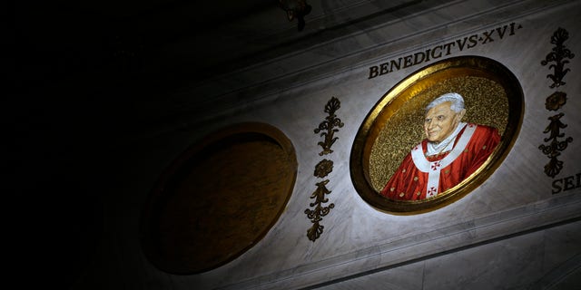 The icon of Pope Benedict XVI is lit inside St. Paul Outside the Walls Basilica, in Rome,Tuesday, Feb.12, 2013. With a few words in Latin, Pope Benedict XVI did what no pope has done in more than half a millennium, stunning the world by announcing his resignation Monday, Feb. 11, 2013, and leaving the already troubled Catholic Church to replace the leader of its 1 billion followers by Easter. (AP Photo/Gregorio Borgia)