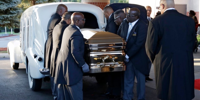 Pallbearers carry the gold casket of legendary singer Aretha Franklin after arriving at the Greater Grace Temple in Detroit, Friday, Aug. 31, 2018. Franklin died Aug. 16 of pancreatic cancer at the age of 76. (AP Photo/Tony Dejak)