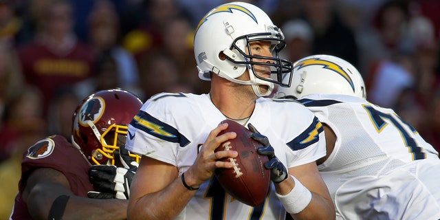 San Diego Chargers quarterback Philip Rivers looks for an open man to pass during the second half of a NFL football game against Washington Redskins in Landover, Md., Sunday, Nov. 3, 2013. (AP Photo/Alex Brandon)