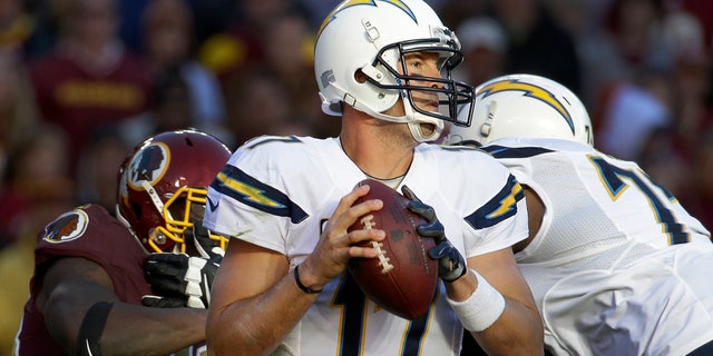 San Diego Chargers quarterback Philip Rivers looks for an open man to pass during the second half of a NFL football game against Washington Redskins in Landover, Md., Sunday, Nov. 3, 2013. (AP Photo/Alex Brandon)