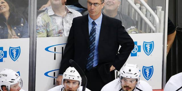 FILE - In this Thursday, Oct. 30, 2014, file photo, Los Angeles Kings assistant coach John Stevens stands behind his bench during the first period of an NHL hockey game against the Pittsburgh Penguins in Pittsburgh. A person with direct knowledge of the situation tells The Associated Press that the Los Angeles Kings will name Stevens their next head coach. Stevens replaces Darryl Sutter after serving as a Kings assistant and then associate coach for the past eight seasons, which included two Stanley Cups. (AP Photo/Gene J. Puskar, File)