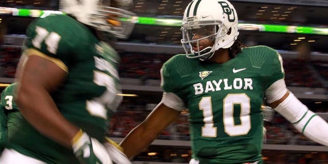 ARLINGTON, TX - NOVEMBER 26: Robert Griffin III #10 of the Baylor Bears celebrates a touchdown against the Texas Tech Red Raiders at Cowboys Stadium on November 26, 2011 in Arlington, Texas. (Photo by Ronald Martinez/Getty Images)