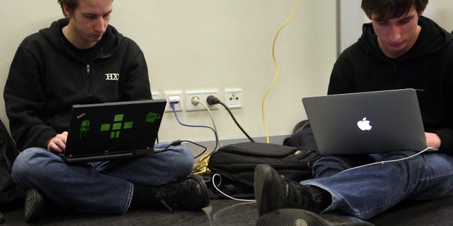 BERLIN, GERMANY - DECEMBER 27: Participants work on laptops on the first day of the 28th Chaos Communication Congress (28C3) - Behind Enemy Lines computer hacker conference on December 27, 2011 in Berlin, Germany. The Chaos Computer Club is Europe's biggest network of computer hackers and its annual congress draws up to 3,000 participants. (Photo by Adam Berry/Getty Images)