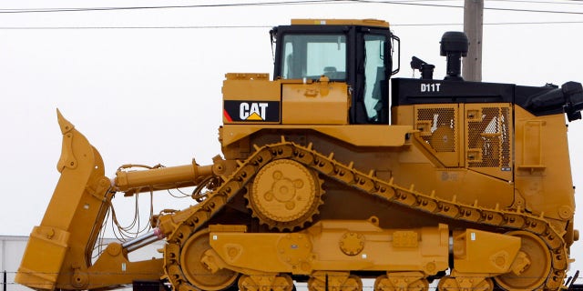 A bulldozer sits on a railcar outside the Caterpillar plant in Peoria, Illinois