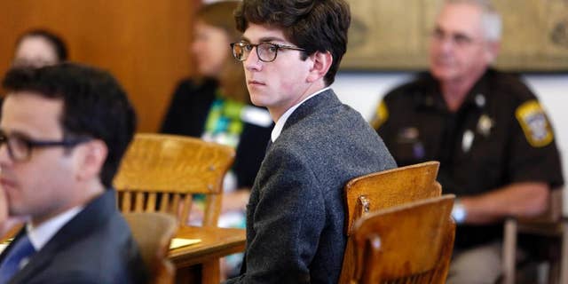 FILE - In this Tuesday Aug. 18, 2015 file photo, St. Paul's School student Owen Labrie looks around the courtroom at the start of his trial. Labrie was convicted of sexually assaulting a 15-year-old freshman girl as part of a game of sexual conquest. Labrie’s new lawyer has submitted arguments for a new trial, saying the emails between Labrie and the 15-year-old girl don't support his computer crime conviction because they were hosted by an intranet server, an weren't sent through the internet, AP Photo/Jim Cole, File)