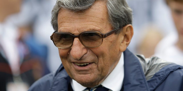 FILE - In this Sept. 12, 2009 file photo, Penn State coach Joe Paterno walks the field before their college football game against Syracuse in State College, Pa.   The Hall of Fame coach died of lung cancer on Jan. 22, 2012, at age 85. On Tuesday, Jan. 22, 2013,  exactly a year after his passing _ community residents have organized a vigil at a downtown mural that includes a depiction of Paterno.  (AP Photo/Carolyn Kaster, File)