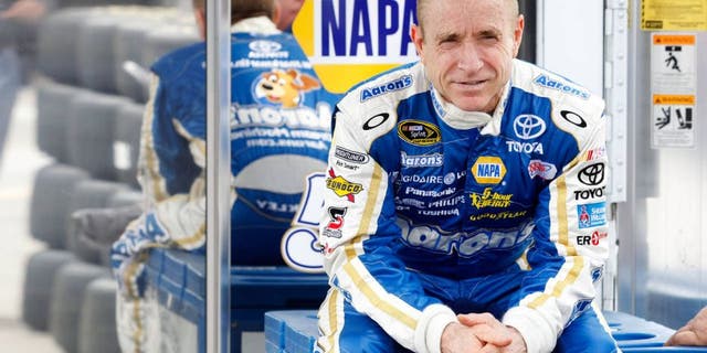 DAYTONA BEACH, FL - FEBRUARY 22: Mark Martin, driver of the #55 Aaron's Toyota, sits behind the team hauler in the garage area during practice for the NASCAR Sprint Cup Series Daytona 500 at Daytona International Speedway on February 22, 2012 in Daytona Beach, Florida. (Photo by Todd Warshaw/Getty Images for NASCAR)