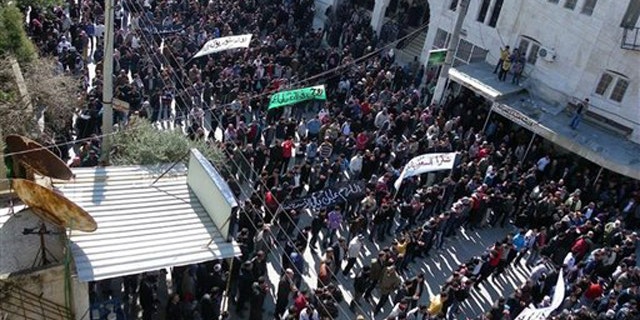 March 2, 2012: Anti-Syrian regime protesters hold up banners during a demonstration in Idlib, Syria.