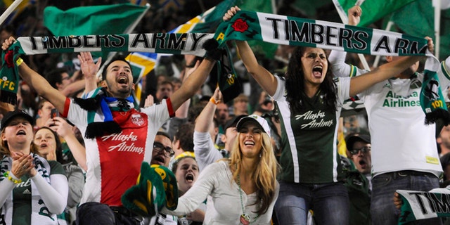 Portland Timbers' fans celebrate the win against Seattle in an MLS Soccer game in Portland, Ore, on Oct. 13, 2013.