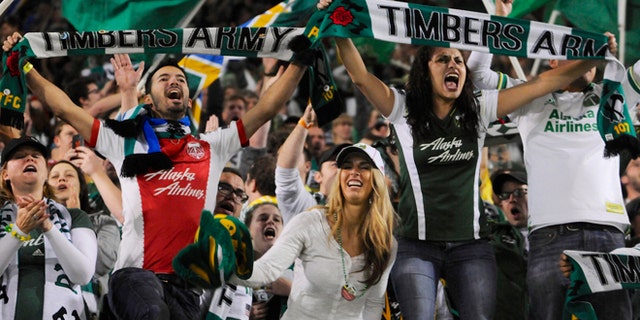 Portland Timbers fans celebrate the win against Seattle in an MLS Soccer game in Portland, Ore, on Oct. 13, 2013. (Associated Press)