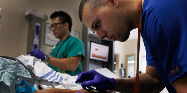 MIAMI, FL - APRIL 30:  Paramedic Christopher Gutierrez prepares to draw blood from a patient at the University of Miami Hospital's Emergency Department on April 30, 2012 in Miami, Florida. As people wait to hear from the United States Supreme Court on its decision of the constitutionality of the Affordable Care Act, some experts say that if the act is overturned, a decision expected later this year, people that now have insurance will no longer be eligible and will be kicked back into a system where the emergency department is their first visit when sick.  (Photo by Joe Raedle/Getty Images)