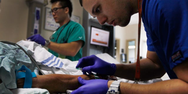 MIAMI, FL - APRIL 30: Paramedic Christopher Gutierrez prepares to draw blood from a patient at the University of Miami Hospital's Emergency Department on April 30, 2012 in Miami, Florida. As people wait to hear from the United States Supreme Court on its decision of the constitutionality of the Affordable Care Act, some experts say that if the act is overturned, a decision expected later this year, people that now have insurance will no longer be eligible and will be kicked back into a system where the emergency department is their first visit when sick. (Photo by Joe Raedle/Getty Images)