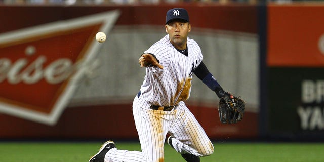 June 18, 2012: Derek Jeter of the New York Yankees flips the ball to second base to end the seventh inning from a ball hit by Michael Bourn of the Atlanta Braves during their game at Yankee Stadium in New York City. (Al Bello/Getty Images)