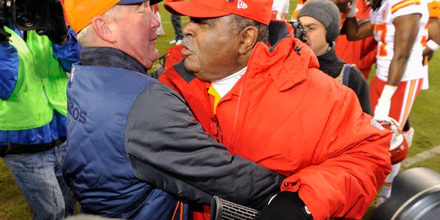 Denver Broncos head coach John Fox, left, greets Kansas City Chiefs coach Romeo Crennel at the end of an NFL football game, Sunday, Dec. 30, 2012, in Denver. Denver won 38-3. (AP Photo/Jack Dempsey)
