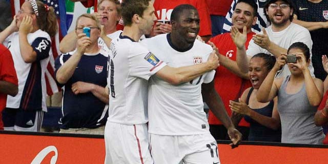 USA attacker Jozy Atidore (17) is congratulated by teammate Clarence Goodson (21) following his goal against Guadeloupe during the first half of a Gold Cup soccer match in Kansas City, Kan., Tuesday, June 14, 2011. (AP Photo/Orlin Wagner)