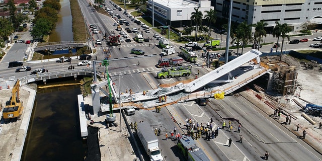 A collapsed pedestrian bridge is seen near the campus of Florida International University in Miami.