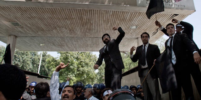 Pakistani lawyers chant anti-U.S. slogans during a demonstration, near an area that houses the U.S. Embassy and other foreign missions in Islamabad, Pakistan on Wednesday, Sept. 19, 2012. The demonstration in Islamabad followed three days of violent protests against an anti Islam film in Pakistan in which two people were killed. Over two dozen more have been killed in protests in other parts of the Muslim world over the past week, including the U.S. ambassador in Libya. (AP Photo/Anjum Naveed)