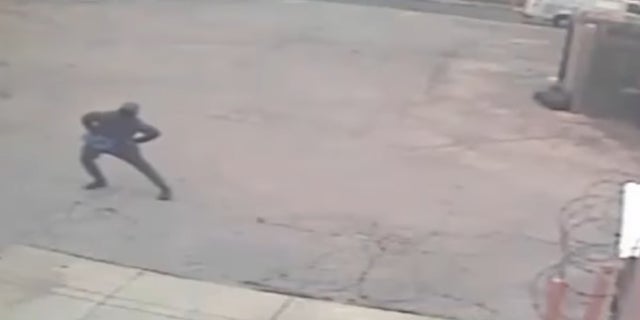 The suspect stretching before robbing a Dunkin' Donuts.