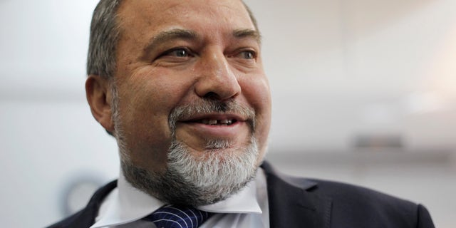 FILE - In this Sunday, Feb. 17, 2013 file photo, Israel's hard-line former Foreign Minister Avigdor Lieberman arrives at a Jerusalem court for the opening hearing of his trial on charges of fraud and breach of trust. Israel's political system is holding its collective breath ahead of Wednesday’s verdict in the graft trial of Lieberman. (AP Photo/Ariel Schalit, File)