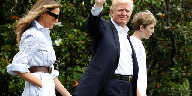 U.S. President Donald Trump with first lady Melania and their son Barron walk out from the White House in Washington, U.S., before their departure to Camp David, June 17, 2017. REUTERS/Yuri Gripas - RTS17H1T