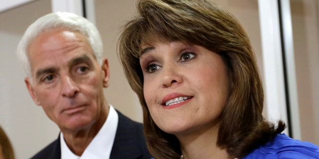 FILE - In this July 17, 2014 file photo, Annette Taddeo-Goldstein, right, talks to reporters during a news conference as former Gov. Charlie Crist listens in Miami. Crist picked former congressional candidate and Miami-Dade County Democratic Party chairwoman Annette Taddeo-Goldstein as his running mate. After years of running few Latinos for statewide posts, Democrats are building a bench that better reflects the support they have in the Hispanic community: more than twice as many Hispanics identify as Democrats than Republicans nationally, according to polls. This year they are showcasing this bench in key states that not only have large Hispanic electorates but enough electoral votes to swing presidential elections. The shift is crucial for a party that often fails to get its Hispanic supporters to the polls. (AP Photo/Alan Diaz)