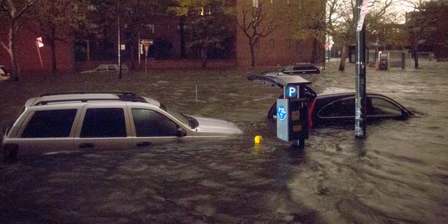 Oct. 29, 2012: Vehicles are submerged on 14th Street near the Consolidated Edison power plant Monday in New York City.