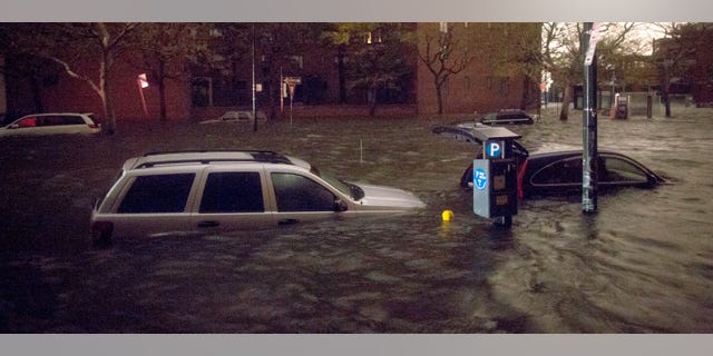 Oct. 29, 2012: Vehicles are submerged on 14th Street near the Consolidated Edison power plant Monday in New York City.