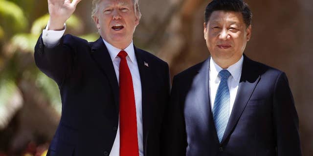 FILE - In this Friday, April 7, 2017, file photo, U.S. President Donald Trump, left, and Chinese President Xi Jinping pause for photographs at Mar-a-Lago in Palm Beach, Fla. North Korea often marks significant dates by displaying military capability, and South Korean officials say there's a chance the country will conduct its sixth nuclear test or its maiden test launch of an ICBM around the founding anniversary of its military on Tuesday, April 25. Trump spoke by phone with both the Japanese and Chinese leaders Monday, April 24. China's official broadcaster CCTV quoted Xi telling Trump that China strongly opposed North Korea's nuclear weapons program and hoped "all parties will exercise restraint and avoid aggravating the situation." (AP Photo/Alex Brandon, File)