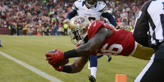 Delanie Walker #46 of the San Francisco 49ers dives over the goal line scoring on a thirty two yard touchdown pass in the first quarter against the San Diego Chargers during an NFL pre-season football game at Candlestick Park on August 30, 2012 in San Francisco, California. (Photo by Thearon W. Henderson/Getty Images)