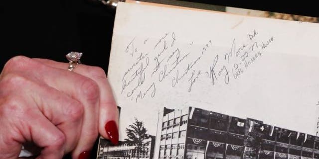Beverly Nelson shows reporters her high school yearbook on Nov. 13, which she says Roy Moore signed: "To a sweeter more beautiful girl I could not say 'Merry Christmas.'"
