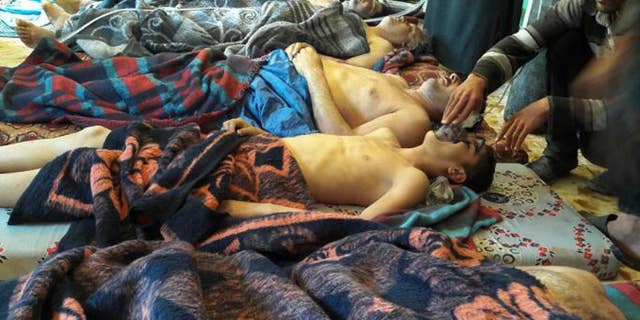 FILE -- In this Tuesday, April 4, 2017 file photo, victims of the suspected chemical weapons attack lie on the ground, in Khan Sheikhoun, in the northern province of Idlib, Syria. France's foreign minister says chemical analysis of samples taken from a deadly sarin gas attack in Syria shows that the nerve agent used "bears the signature" of President Bashar Assad's government and shows it was responsible. (Alaa Alyousef via AP, File)