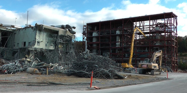 In this photo taken Tuesday, Nov. 12, 2013, workers continue the process of demolishing chemical waste incinerator at the Anniston Army Depot in Anniston, Ala. The Pentagon spent $10.2 billion over three decades burning chemical weapons stored in four states. Now, with those chemicals up in smoke and communities freed of a threat, the Army’s in the middle of another, $1.3 billion project: Demolishing the incinerators that destroyed the toxic materials. (AP Photo/Jay Reeves)