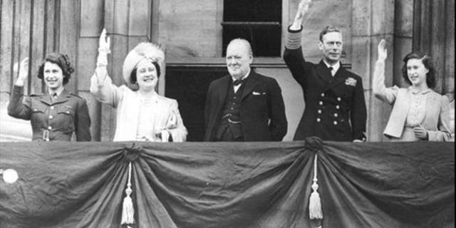 Da esquerda para a direita, a princesa Elizabeth, a rainha Elizabeth, o primeiro-ministro Winston Churchill, o rei George VI e a princesa Margaret da Grã-Bretanha acenam para a multidão da varanda do Palácio de Buckingham durante as comemorações do dia VE em 8 de maio de 1945.