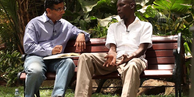 This publicity image released by Rocky Mountain Pictures, shows an undated film clip of director, Dinesh D'Souza, interviewing George Obama in "2016: Obama's America."