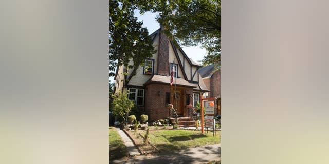 FILE - This Tuesday, Oct. 18, 2016 file photo, shows the exterior of a house in the Jamaica Estates neighborhood of the Queens borough of New York, where Republican presidential candidate Donald Trump spent his early childhood. Trump’s boyhood home in New York City is going back on the auction block. Paramount Realty said the 1940 Tudor-style house in Jamaica Estates in Queens is being offered Jan. 17, 2017. (AP Photo/Mary Altaffer, File)