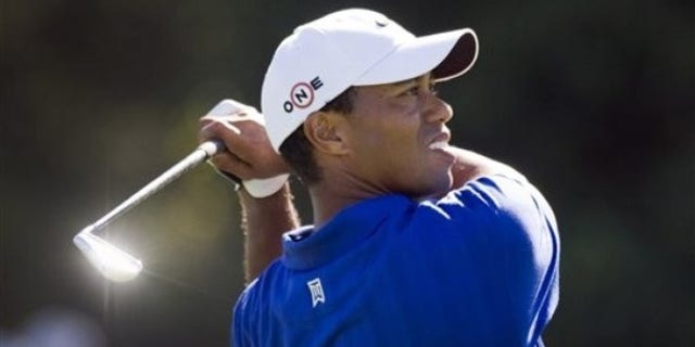 Tiger Woods from the United States hits an approach shot during the second round of the Australian Masters golf tournament at the Kingston Heath Golf Club in Melbourne, Australia, Friday, Nov. 13, 2009. Woods was at 10-under 134. (AP Photo/Andrew Brownbill)