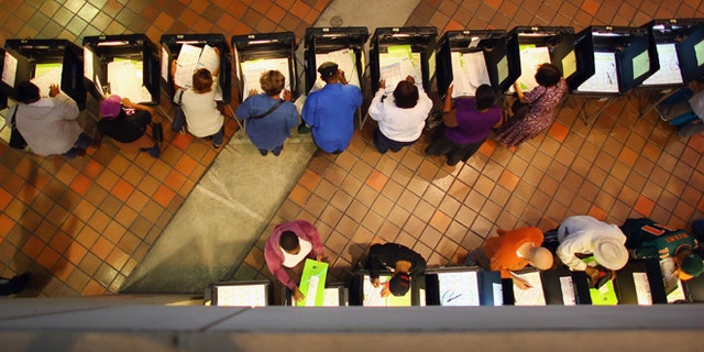 MIAMI, FL - OCTOBER 27:  Early voters fill out their ballots as they cast their vote in the presidential election on the first day of early voting, at the Stephen P. Clark Government Center on October 27, 2012 in Miami, Florida. Early voting in one of the important swing states is held for eight straight 12-hour days, leading up to the November 6 general election.  (Photo by Joe Raedle/Getty Images)