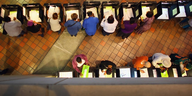 MIAMI, FL - OCTOBER 27: Early voters fill out their ballots as they cast their vote in the presidential election on the first day of early voting, at the Stephen P. Clark Government Center on October 27, 2012 in Miami, Florida. Early voting in one of the important swing states is held for eight straight 12-hour days, leading up to the November 6 general election. (Photo by Joe Raedle/Getty Images)