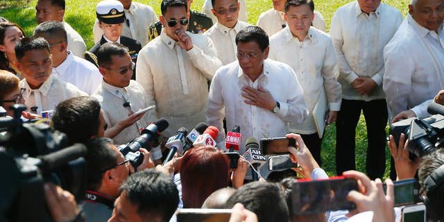 Philippine President Rodrigo Duterte talks to the media prior to a welcoming ceremony for Indonesian President Joko Widodo, at Malacanang Palace grounds in Manila, Philippines Friday, April 28, 2017. When Duterte hosts a summit of Southeast Asian leaders this weekend, the spotlight will be on him. Just less than a year in power, Duterte faces a mass murder complaint before the International Criminal Court and an impeachment bid at home as bodies continue to pile up in his war on illegal drugs.(AP Photo/Bullit Marquez)